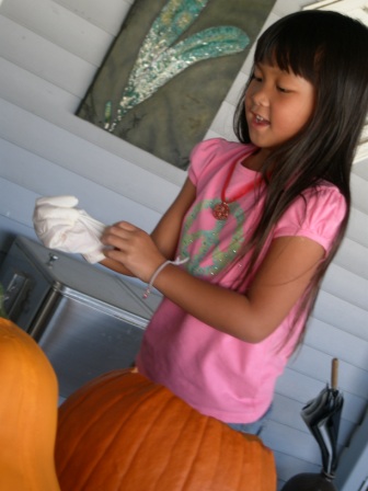 Kasen getting gloves for cleaning out pumpkin